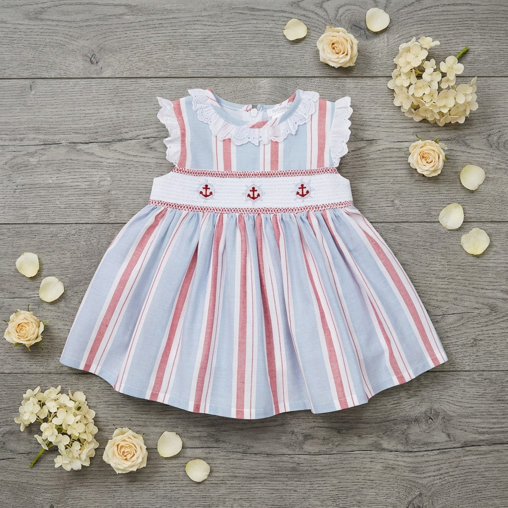 Striped dress with anchor pattern on a wooden surface with flowers